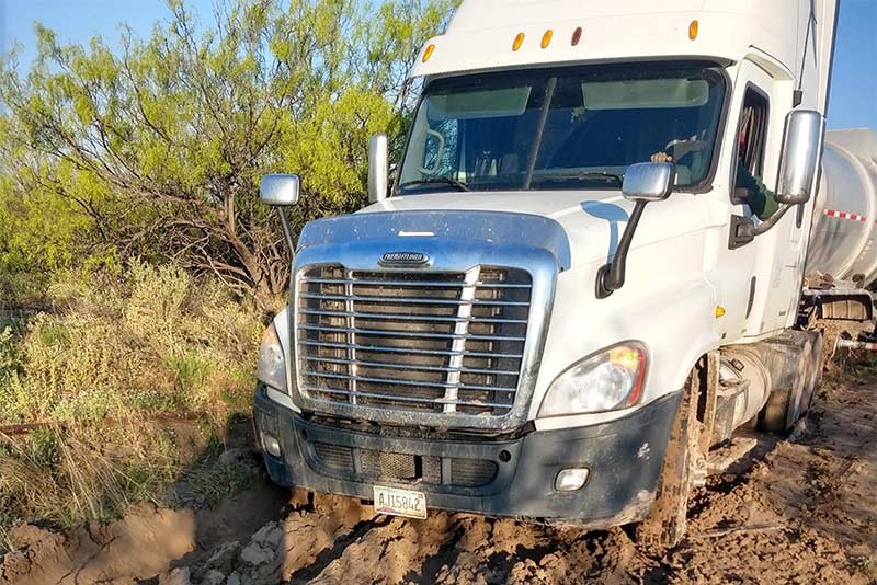 Tractor trailer stuck in mud Team America Towing Odessa Tow Service